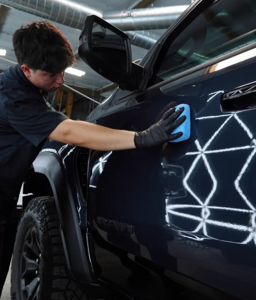 JJ detailing a black truck under hexagon lights